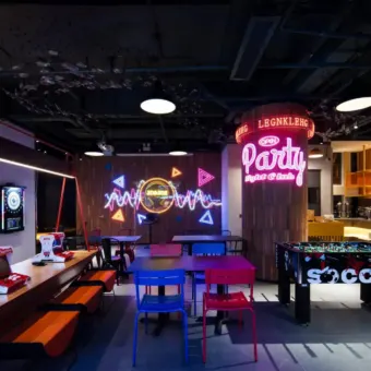 Bar lounge with neon signs and a foosball table at JO&JOE China