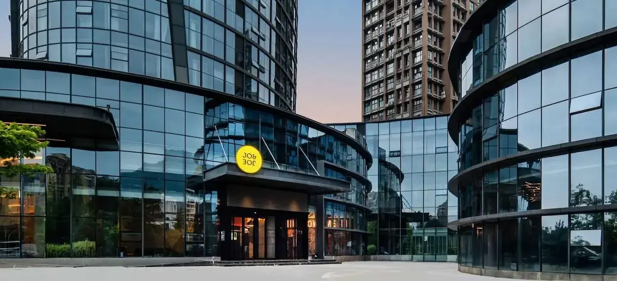 Entrance of JO&JOE Chengdu Dujiangyan in a glass building