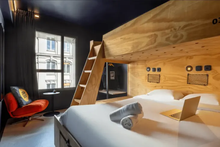 Chambre privée avec lit double et lit mezzanine en bois au JO&JOE Paris Nation
