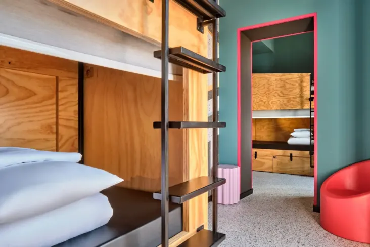 Lits superposés en bois dans un dortoir au JO&JOE Rome